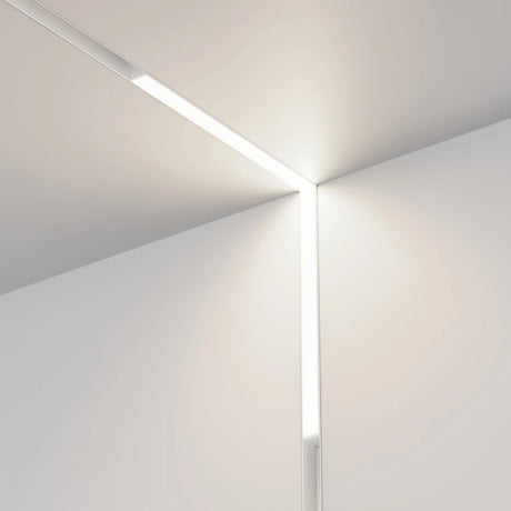 A modern, L-shaped LED light fixture with a sleek black frame and a soft white glow. It has a minimalist design, showcasing small cut-out details along the edges.