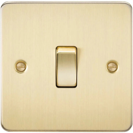 A brass-colored light switch with a simple, rectangular design. It features a single toggle button centered between two screws on a smooth, square faceplate.