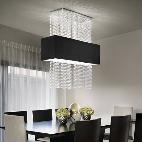 A modern dining room features a rectangular chandelier with cascading crystal strands over a dark wooden table. Six chairs surround the table, which is decorated with two bowls of flowers and a glass vase.