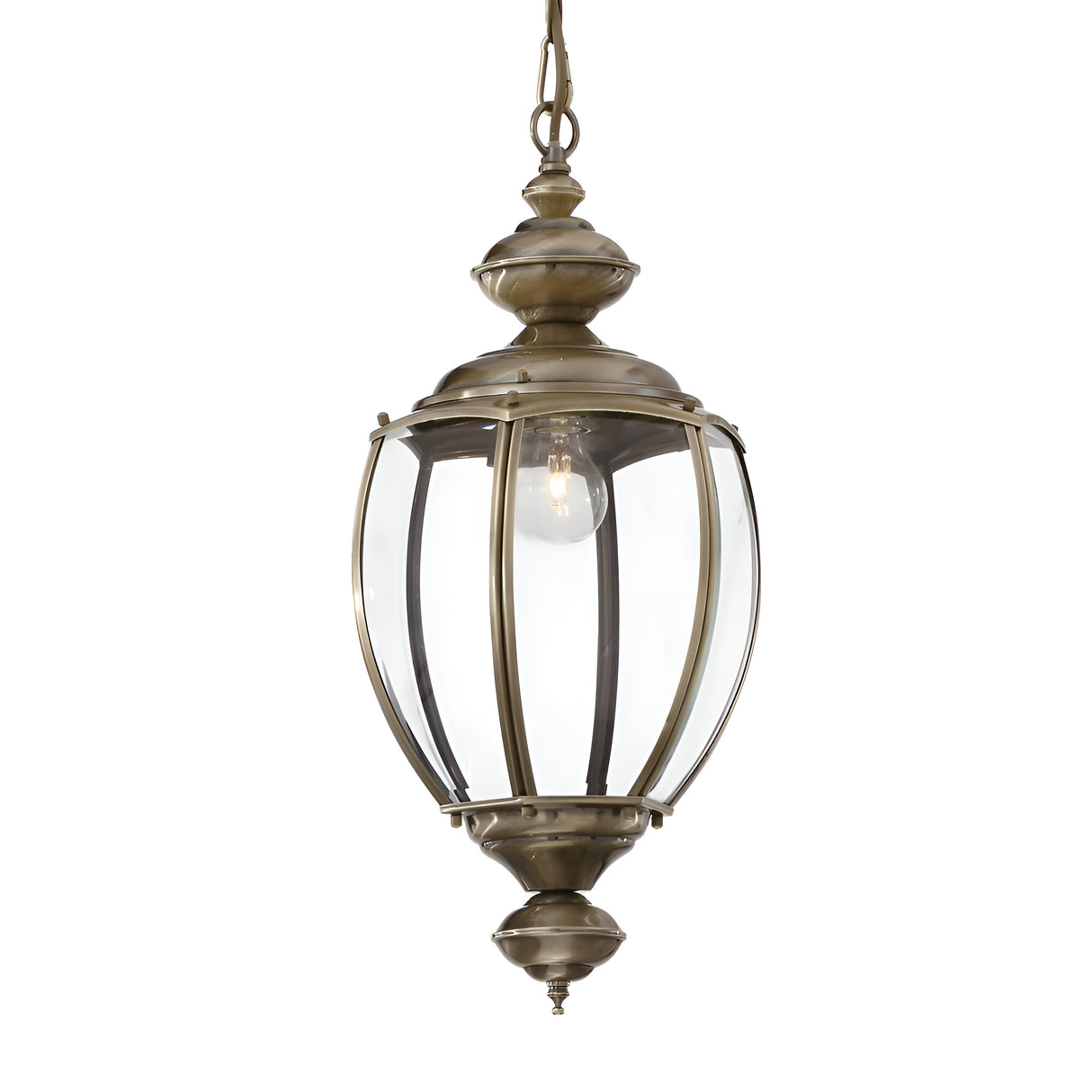 The Ulisse 1 Light Pendant - Brass showcases a vintage-inspired hanging lantern design, complete with clear glass panels and an antique brass finish. It accommodates a single bulb and is suspended by a chain, featuring intricate decorative details at both the top and bottom.