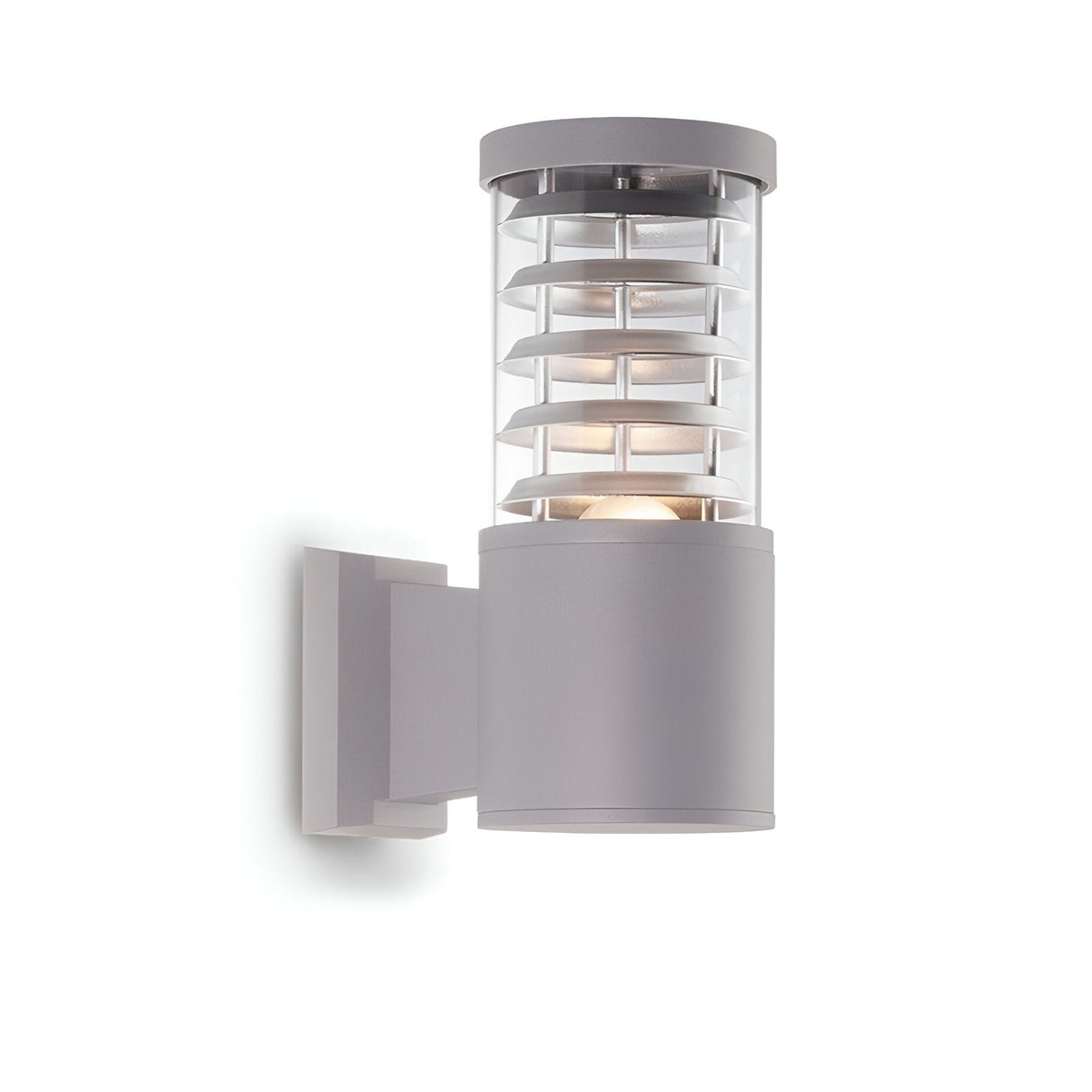 The Luminis Outdoor Wall Light - Grey is a sleek and minimalist outdoor wall sconce with a cylindrical design. It features durable lighting capabilities, horizontal slats surrounding the light, and is mounted on a rectangular wall bracket, making it perfect for any contemporary setting.