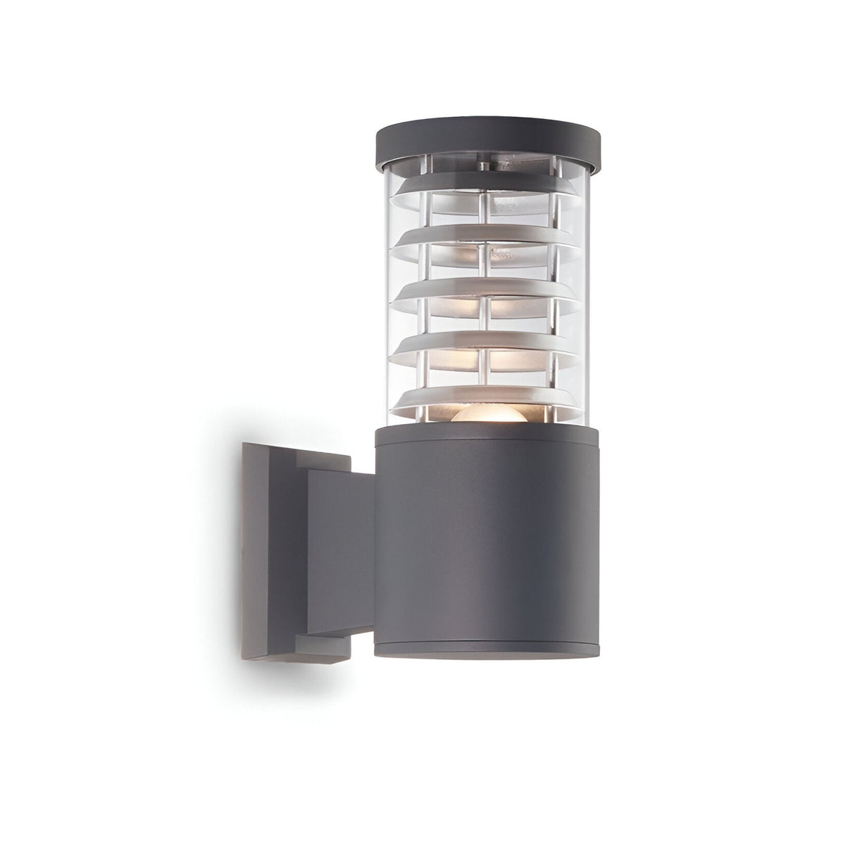 The Luminis Outdoor Wall Light - Anthracite features a modern cylindrical design with a sleek anthracite finish and durable aluminium construction. Horizontal metal bands creatively encircle a clear glass section for illumination, all elegantly mounted on a rectangular base against a white backdrop.