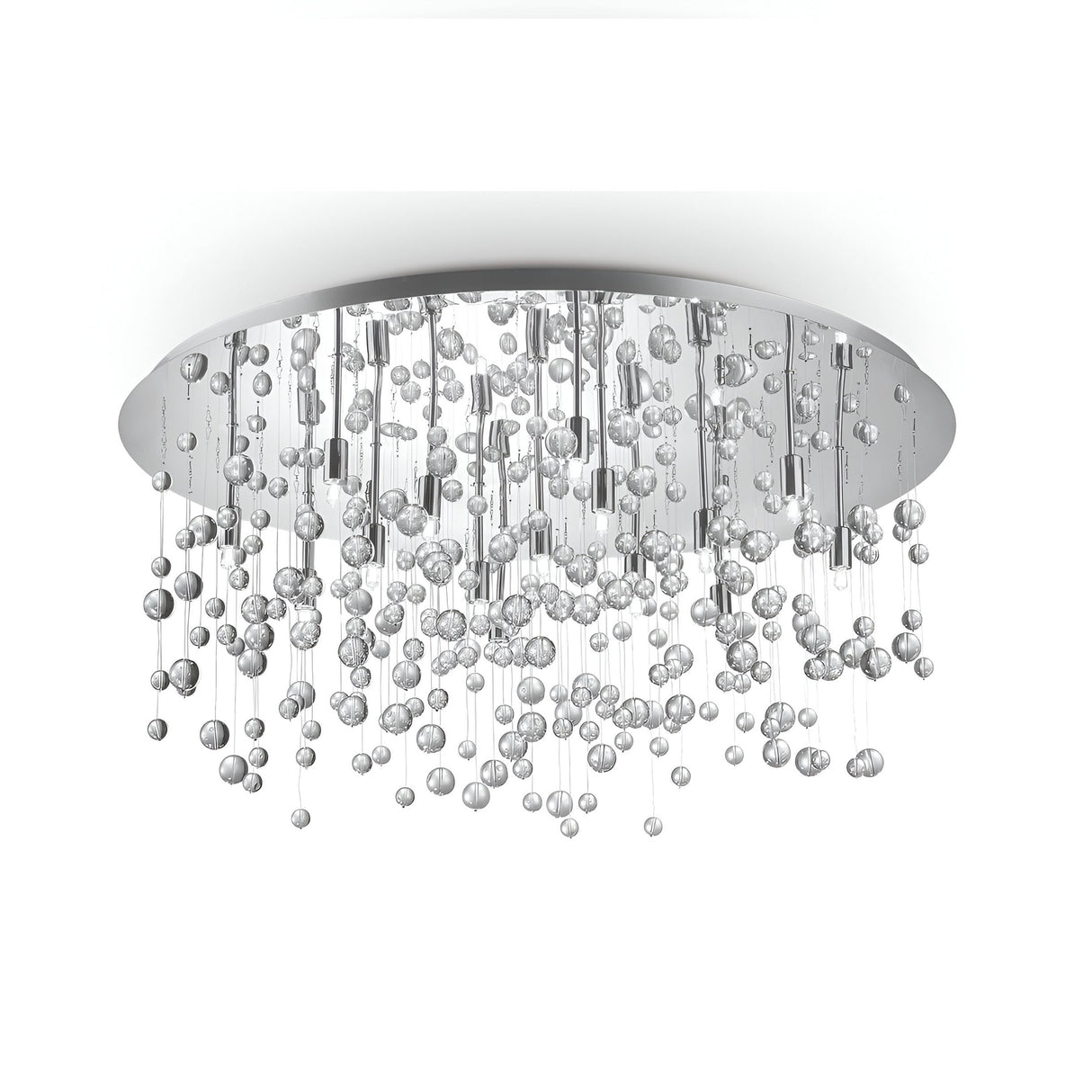 The Illusis 15 Light Glass Semi Flush Chandelier in white offers a sophisticated and shimmering look with its multitude of hanging glass spheres. The fixture includes a round, silver base from which strings of varying lengths suspend the exquisite, crystal-like spheres.