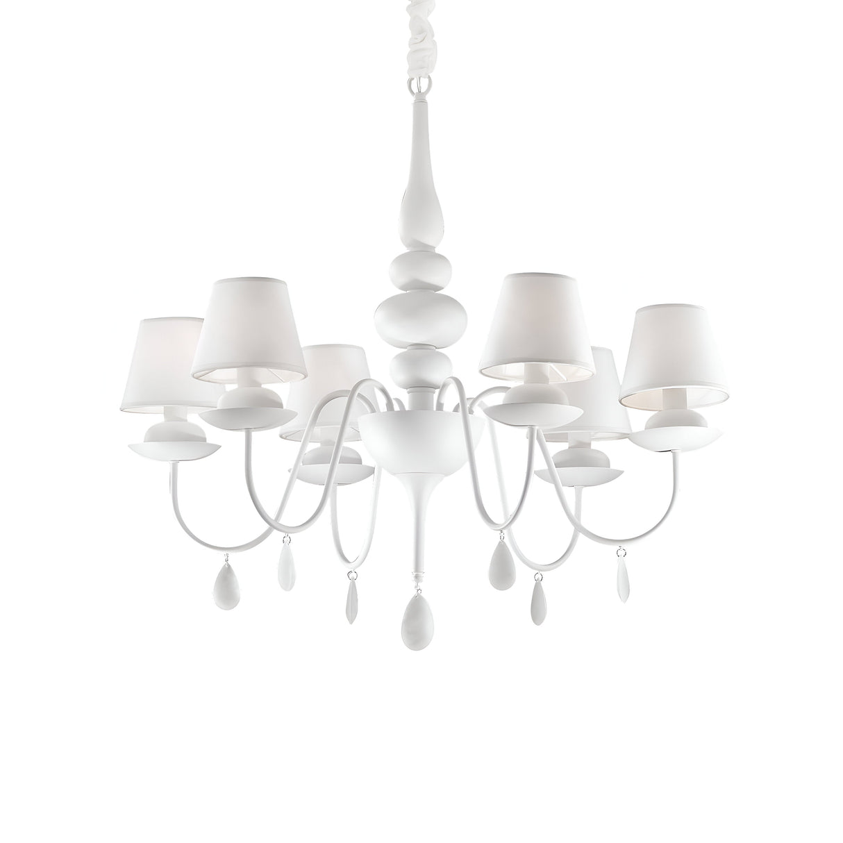The Wisp 6 Light Chandelier in white showcases a sophisticated design featuring six lampshades and intricately curved arms, embellished with teardrop-shaped ornaments. Its stunning white finish is elegantly suspended from a single chain.