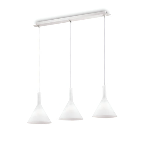 The Vesper 3 Light Bar Pendant - White boasts a minimalist design with three cone-shaped frosted glass shades. Each shade is suspended from adjustable cables, all attached to a rectangular white ceiling mount, resulting in a sleek and modern lighting fixture.