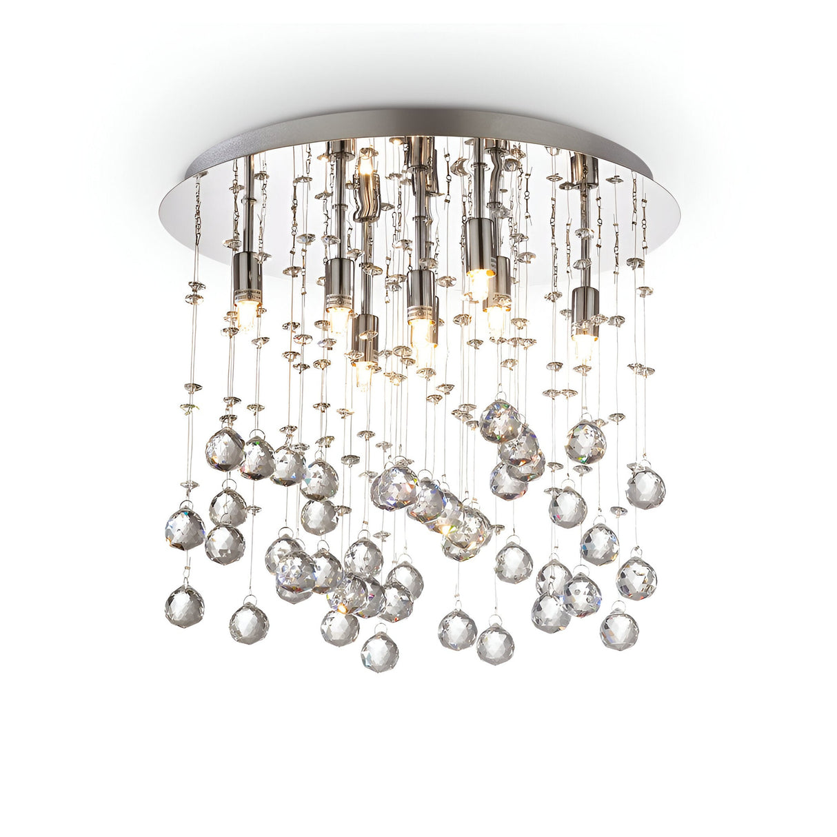 The Solisera 8 Light Crystal Semi Flush Chandelier - Chrome showcases a modern ceiling light design, featuring a chrome round base and adorned with strands of crystal pendants along with small bulbs. This detailed fixture generates a shimmering effect, beautifully enhancing the ambient lighting.