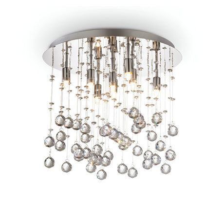 The Solisera 8 Light Crystal Semi Flush Chandelier - Chrome showcases a modern ceiling light design, featuring a chrome round base and adorned with strands of crystal pendants along with small bulbs. This detailed fixture generates a shimmering effect, beautifully enhancing the ambient lighting.