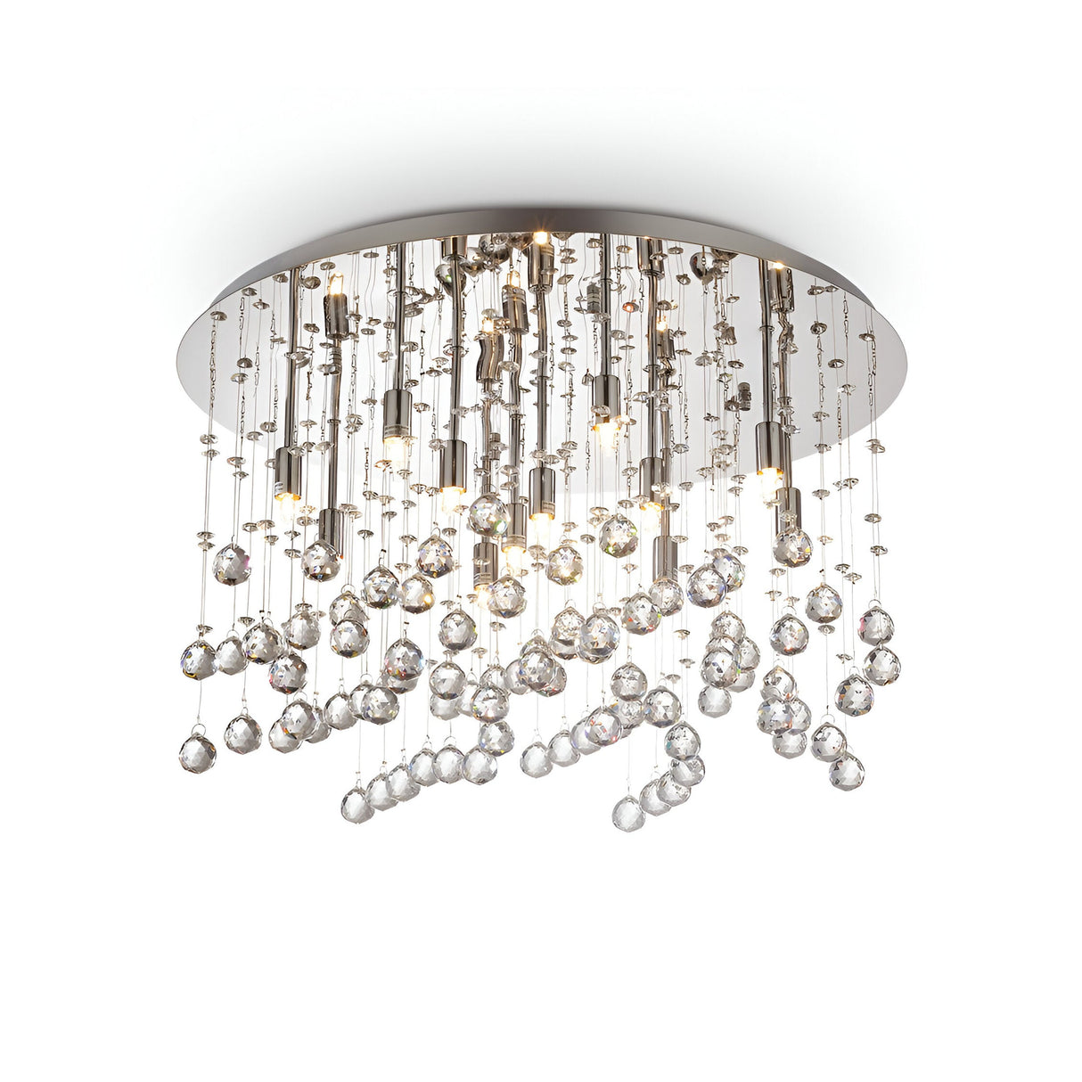 The Solisera 12 Light Crystal Semi Flush Chandelier - Chrome features a modern design with a circular base. It showcases numerous glass crystal strings hanging at varying lengths, creating a shimmering raindrop effect. The chrome finish on the metallic base enhances its elegant appearance.