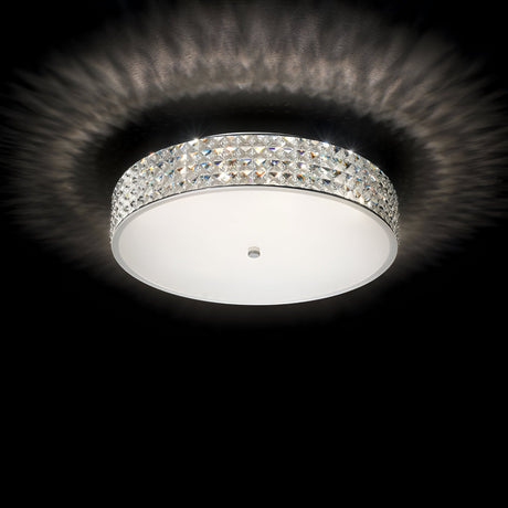 The Nebula 9 Light Crystal Ceiling Light - Chrome elegantly enhances modern interiors with its round fixture and decorative crystal-like edge, emitting a soft, radiant glow against a black background. Its design creates a mesmerizing patterned light effect on the ceiling.