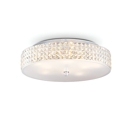 The Nebula 9 Light Crystal Ceiling Light - Chrome is a modern light fixture featuring a round, translucent design with a textured edge. It boasts a smooth, white bottom cover and a central chrome metal piece that complements its soft illumination, making it an ideal choice for modern interiors by blending elegance with contemporary style.