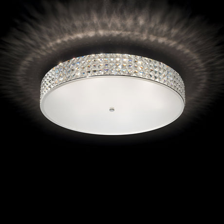 The Nebula 12 Light Crystal Ceiling Light - Chrome features a diamond-patterned crystal border that casts a soft glow against a dark background, epitomizing modern design lighting.