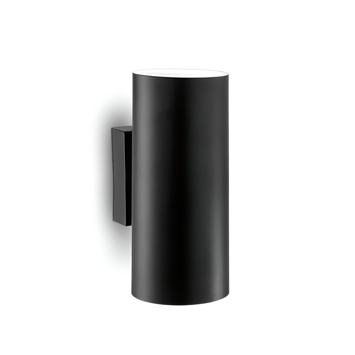 The Noctis 2 Light Wall Light - Black, featuring a matte black finish and cylindrical design, is mounted on a white wall. Its modern aesthetic includes adjustable angles, a minimalist cylindrical form, and a rectangular base for a contemporary look.