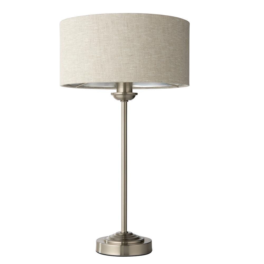 Brenley Table Lamp in brushed chrome with a natural linen drum shade and metallic inner lining, on a slender stem base, shown against a plain white background.
