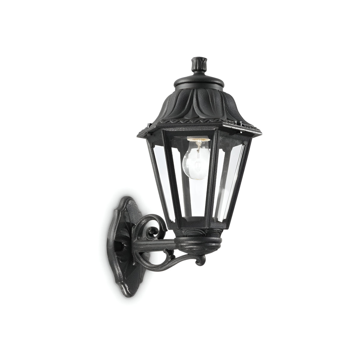 The Gaze Large Outdoor Wall Light in black is a vintage-style fixture that features clear glass panels to showcase a visible bulb inside. Crafted from UV-treated resin, it is mounted on an elegant curved bracket with a lantern-style design.