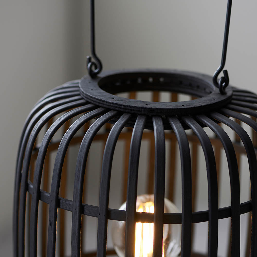 Close-up of Endon Bracken table lamp showing black bamboo cage framework, matt black metal top ring, decorative handle, and a warm filament E27 bulb.