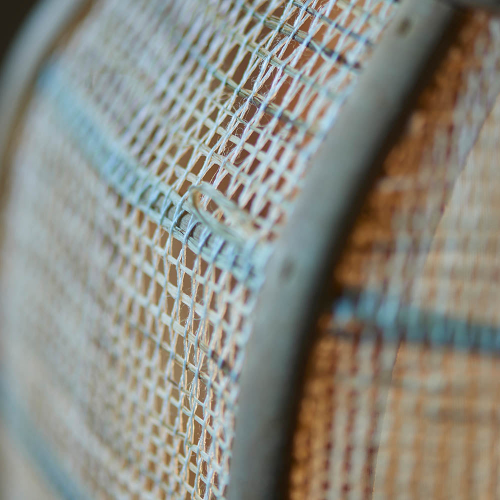 Close-up of the Endon Daneshaw table lamp shade, showing the handmade woven natural linen and bamboo texture in soft focus.