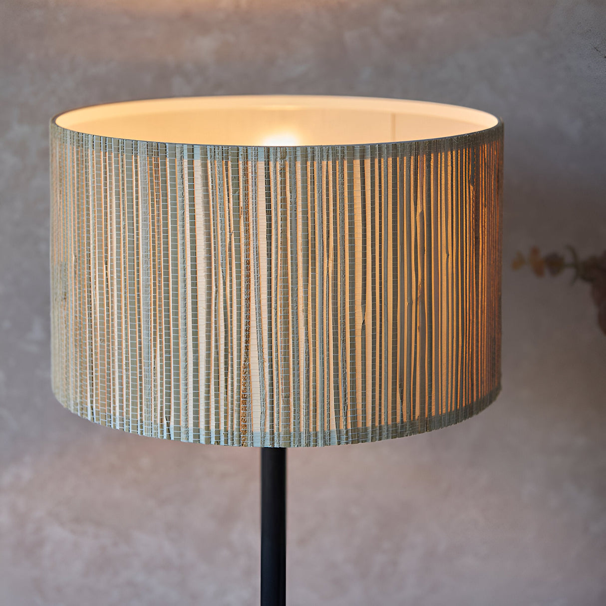 Salcombe Table Lamp with woven seagrass drum shade on a matt black metal base, single E27 bulb, shown lit against a neutral background.