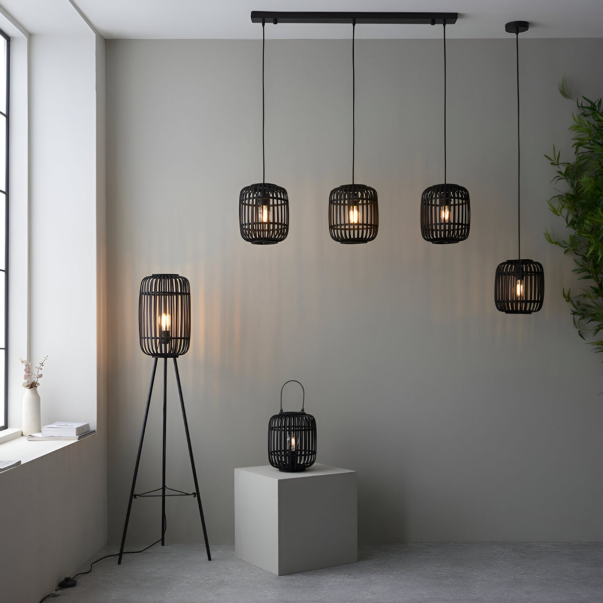 Endon Bracken 3 Light Pendant in black with linear bar and bamboo cage shades, shown in a living space with a matching floor lamp and lantern.