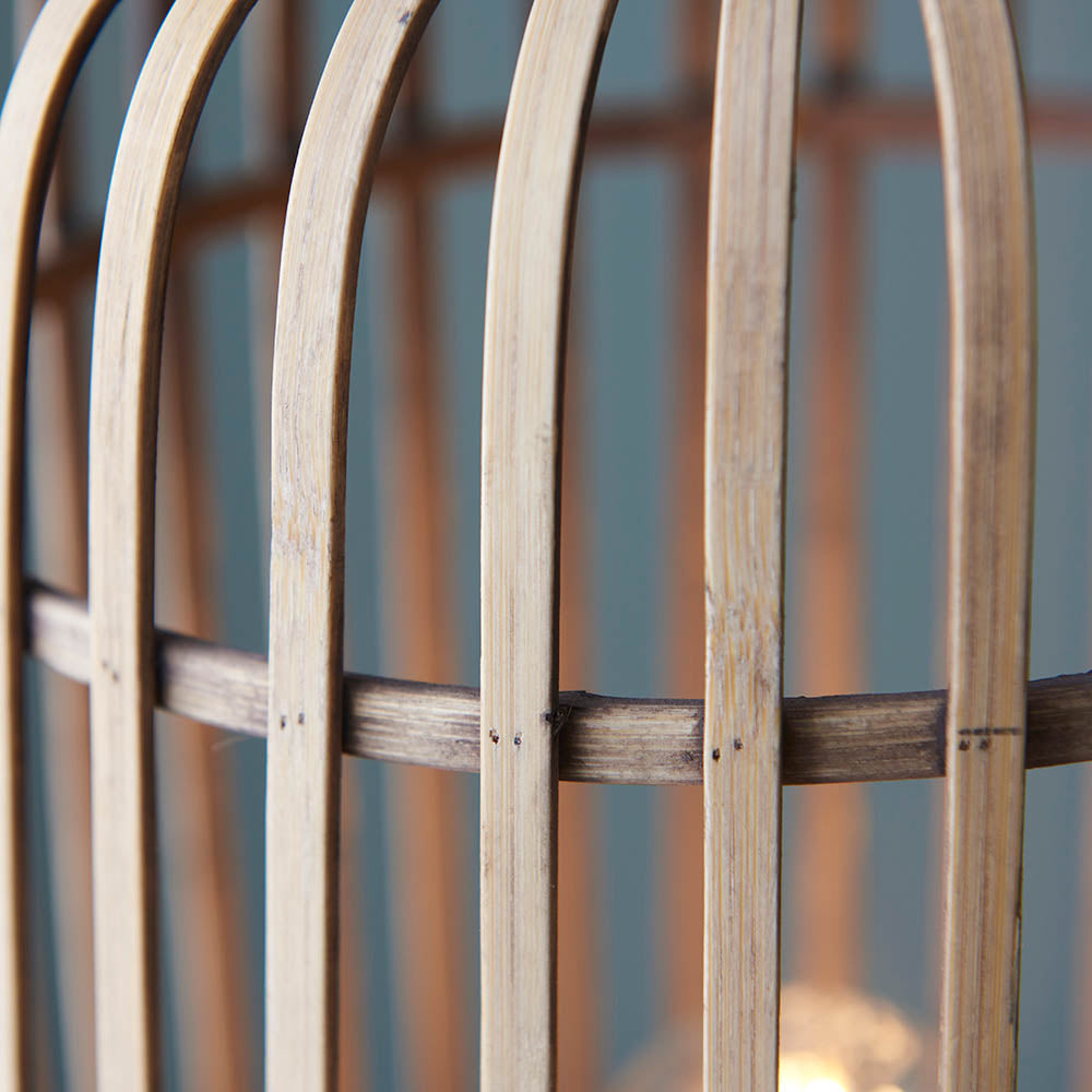 Close-up of the Bracken Floor Lamp's natural bamboo cage frame with black metal band, showing vertical wooden slats and joinery detail.