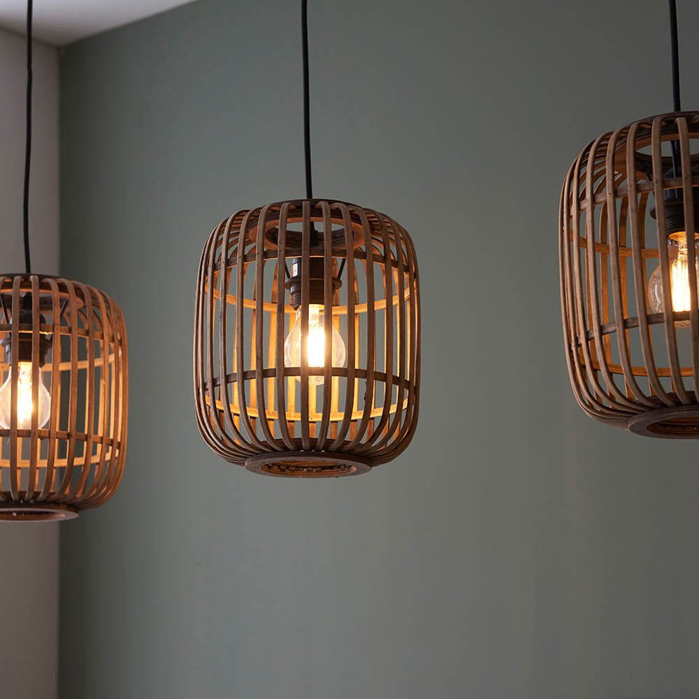 Endon Bracken pendant lights with natural bamboo cage shades and matt black fittings, each holding a lit E27 filament bulb against a soft grey wall.