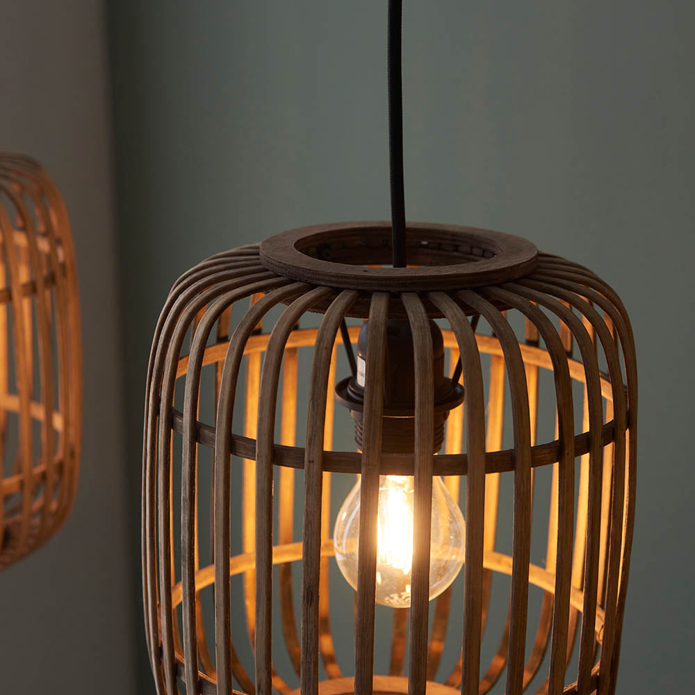 Close-up of Endon Bracken pendant light showing a lit E27 filament bulb inside an open natural bamboo cage shade with matt black fittings.