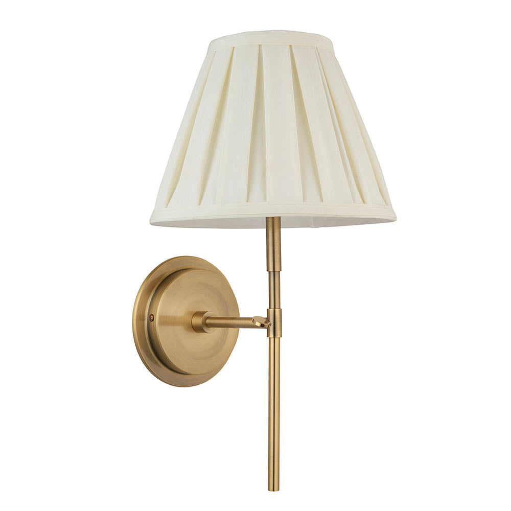 Endon Chartwell wall light with pleated cream cotton tapered shade and antique brass bracket, single E14 lamp, shown on a plain white background.