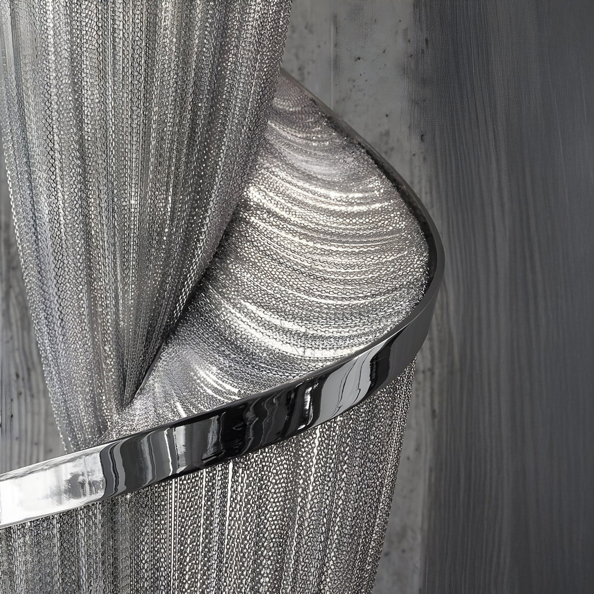 A close-up of the Stratiform 12 Light Metal Chain Veil Vertical Chandelier in a nickel finish, featuring chain-like detailing and architectural lighting, set against a textured gray wall for an artistic industrial touch.