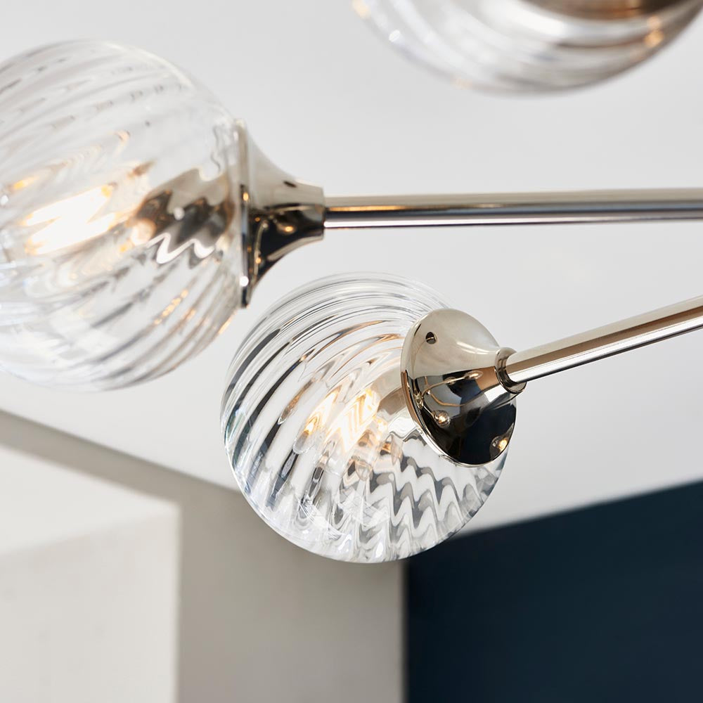 Close-up of Endon Georgiana pendant showing spiral-cut clear glass globe shades on nickel-plated arms fixed to the ceiling.