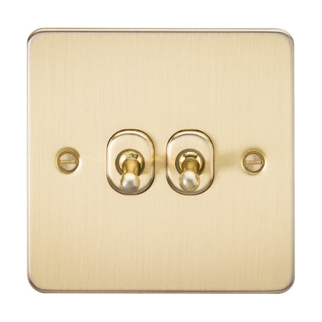 The 10AX 2 Gang 2-Way Toggle Switch in brushed brass, with two central levers on a square plate with rounded edges, offers a sleek finish perfect for contemporary interiors. Two small screws beside the toggles add a touch of charm.