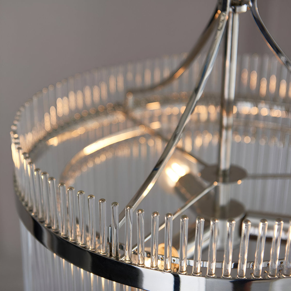 Beaumont 3 Light Pendant in nickel, close-up of clear glass rods framing the round frame with visible bulb and central chrome stem.
