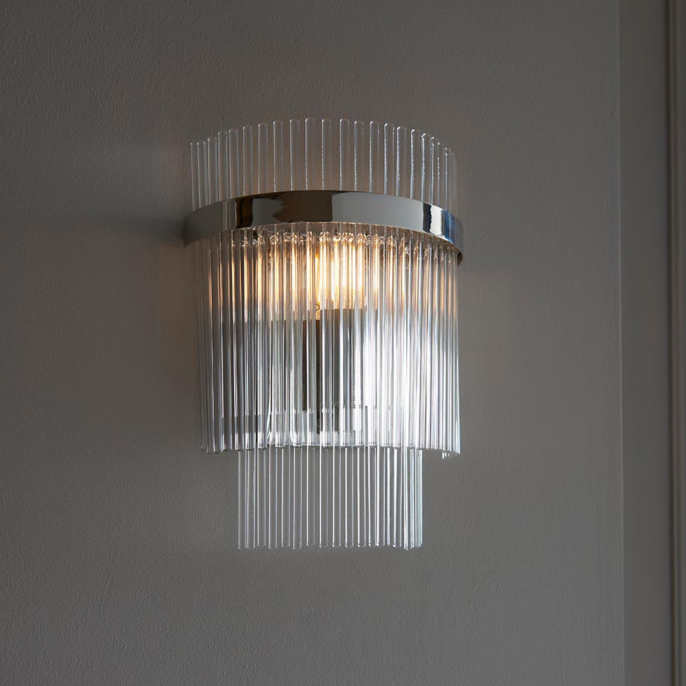 Endon Beaumont wall light in nickel with tiered clear glass rods and a polished chrome band, illuminated against a light grey wall.