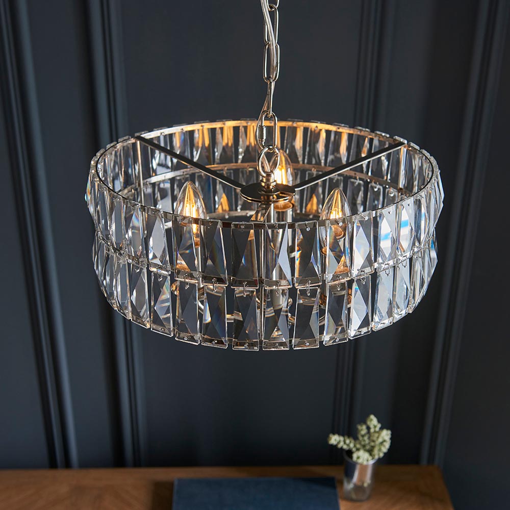 Bevmont 3 Light Pendant in nickel with cut faceted glass drum shade on a chain, shown hanging against a dark panelled wall.
