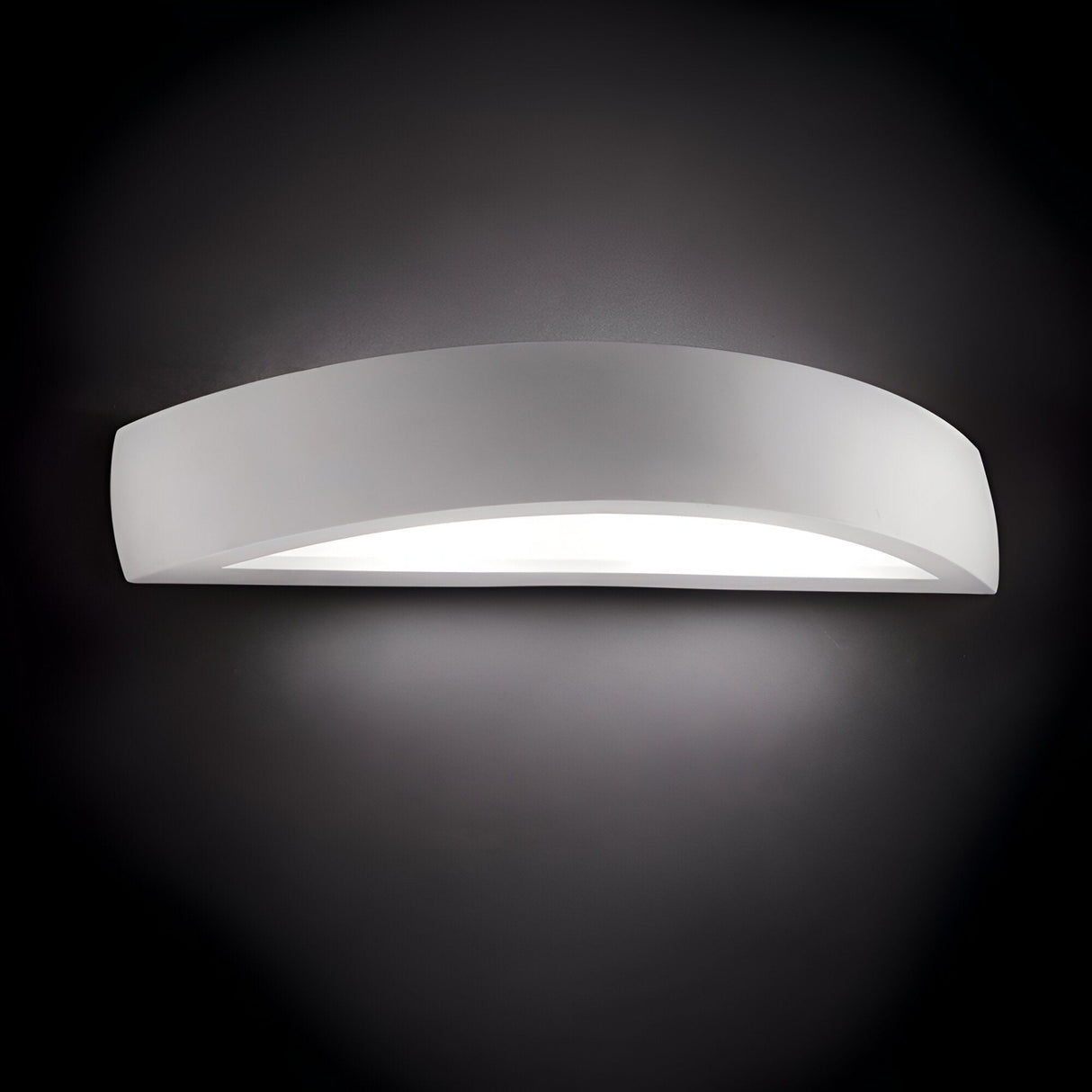 The Terra 2 Light Wall Light - White boasts a modern and minimalist aesthetic with its sleek, curved design and dual light emission. It casts a soft, ambient glow on a dark background, producing a gentle halo effect around the light.