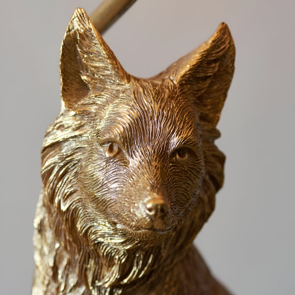 Close-up of the Endon Brambury table lamp's resin fox base, showing hand-painted vintage gold finish with detailed fur texture on the head and ears.