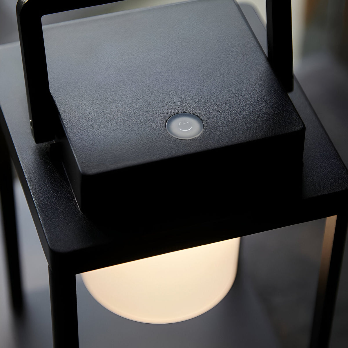Close-up of the Endon Danedon table lamp showing the matt black square top with touch dimmer button and warm white polycarbonate diffuser below.