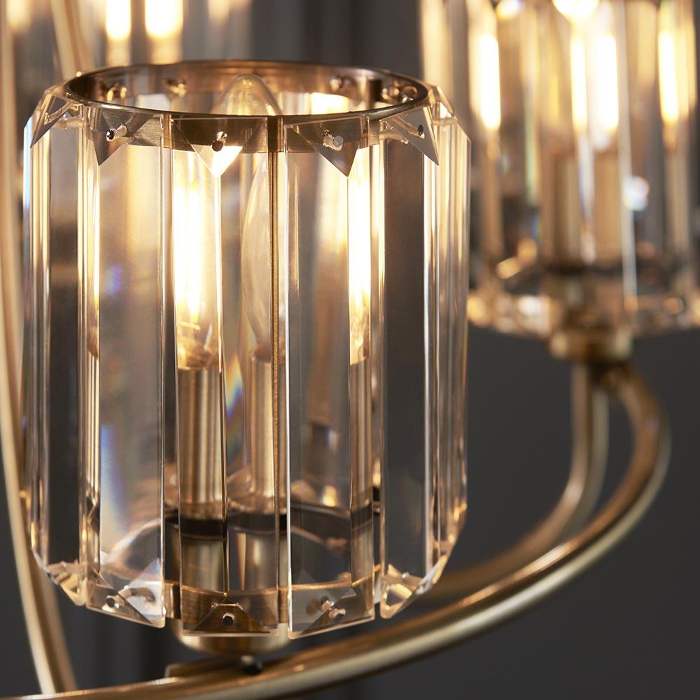 Close-up of Endon Clementine 5 Light Pendant in brass, showing cut faceted clear glass shades on curved plated arms with lit E14 filament lamps.
