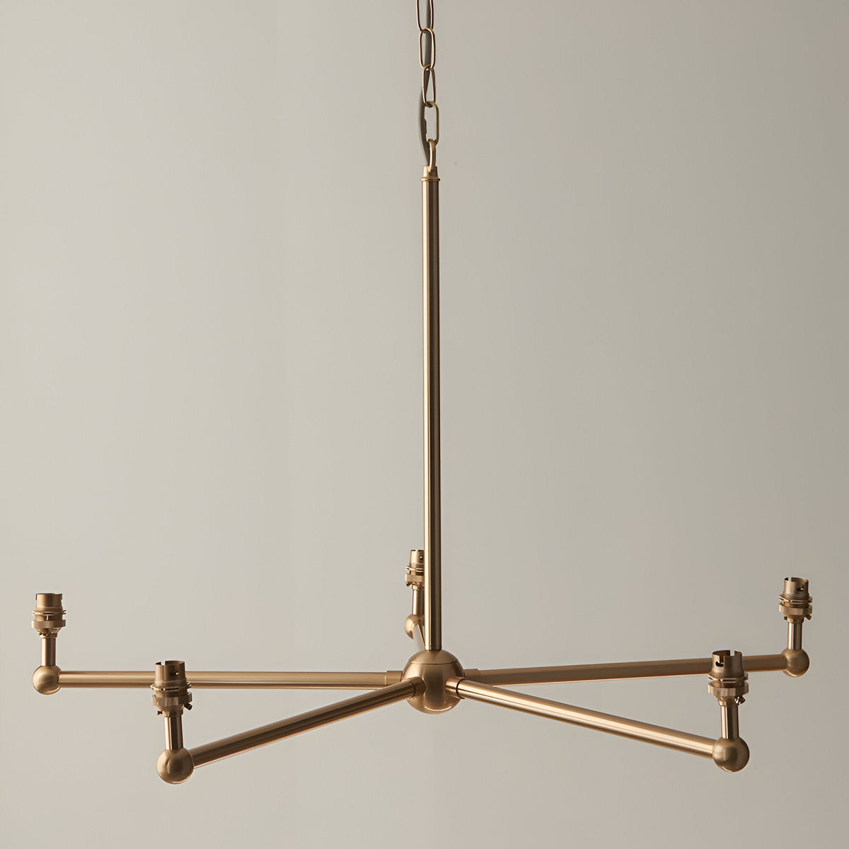 Cliffleigh 5-light pendant in brushed brass with five B22 holders on a star-shaped frame, hung from an adjustable chain.