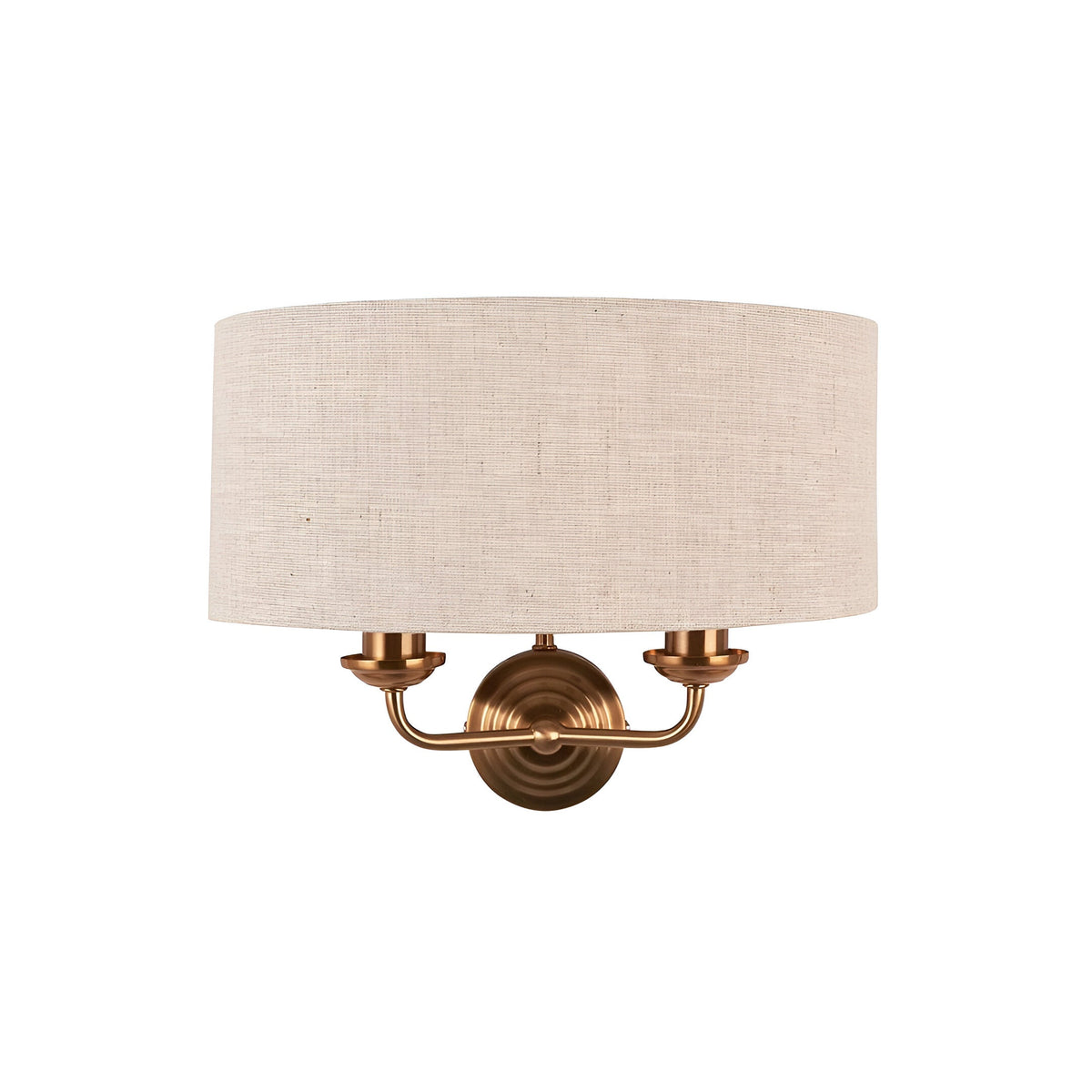 Endon Brenley 2 light wall light with natural linen drum shade on a horizontal vintage brass bar and round backplate, shown on a white background.