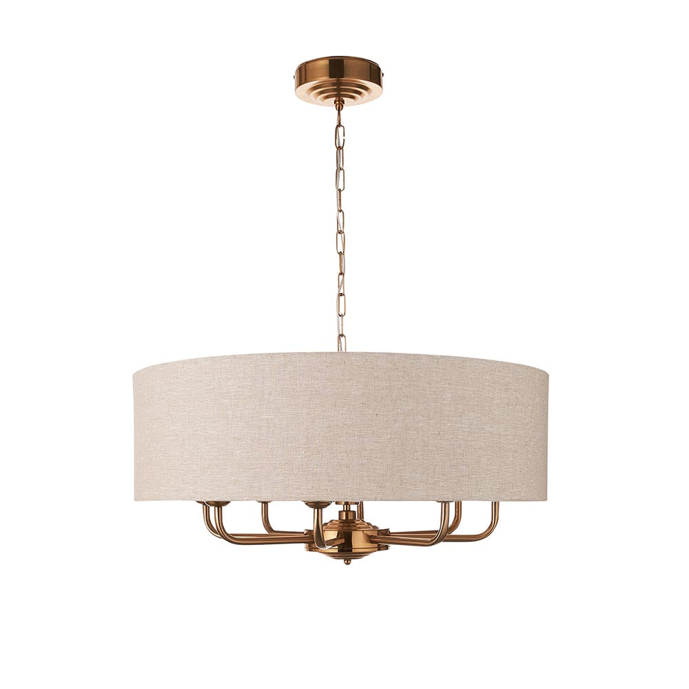 Endon Brenley pendant light with a wide natural linen drum shade and vintage brass frame holding eight E14 lamp arms, shown on a white background.