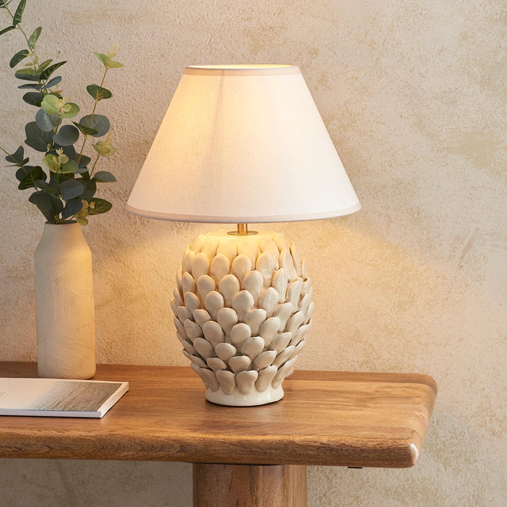 Caldford Small Table Lamp in cream, ceramic base with leaf-textured detail and ivory crackle glaze, topped with a cream tapered fabric shade.