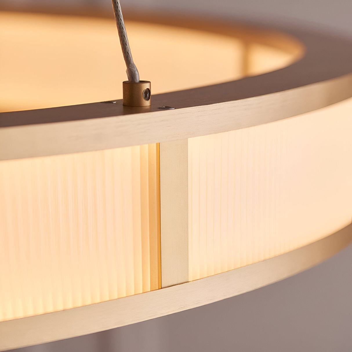 Close-up of the Endon Bevley Ring Pendant in brushed gold, showing the ribbed frosted acrylic diffuser and clear suspension cable fitting.