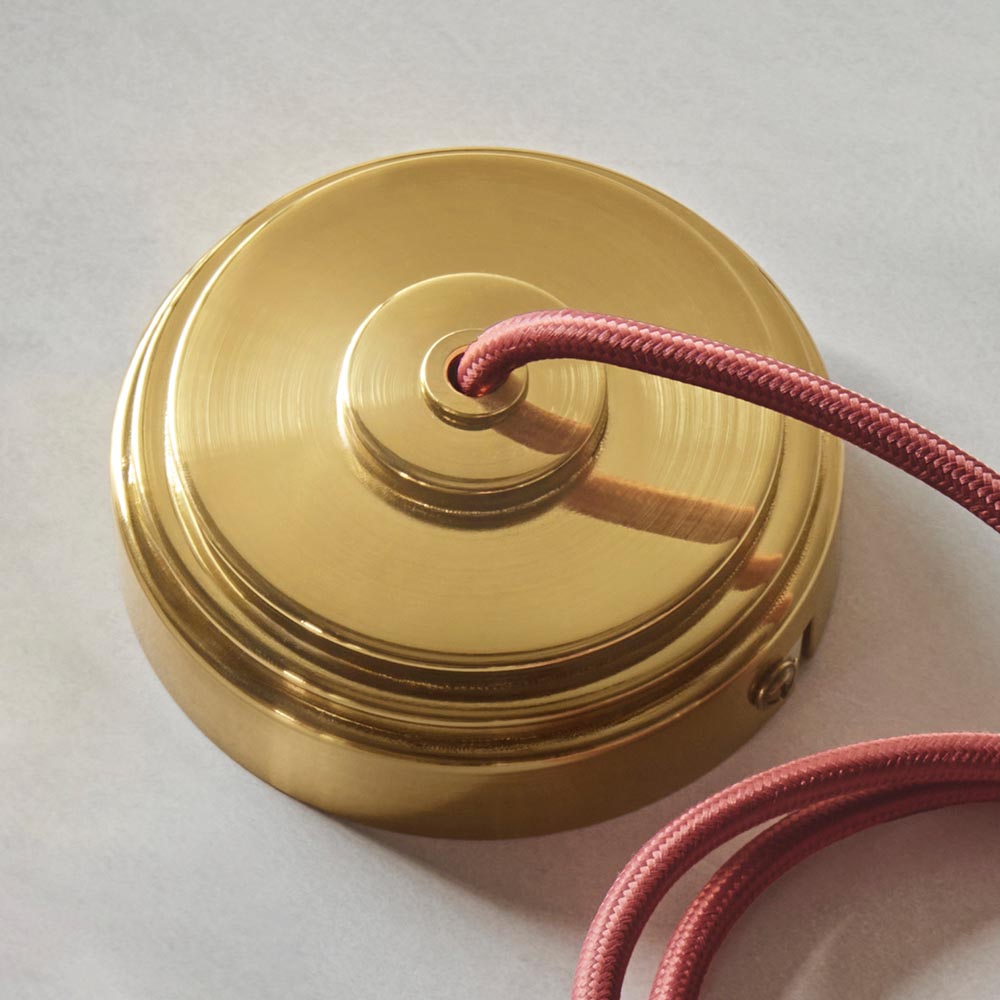Endon Brackmont Flex Set close-up showing the brushed aged brass ceiling rose and red braided fabric cable on a light neutral background.