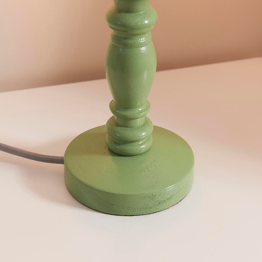 Aldworth Table Lamp base close-up, turned solid wood spindle in green satin finish with grey braided flex, shown on a light surface.