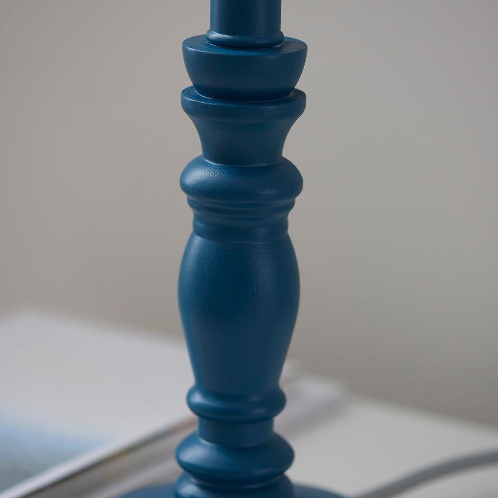 Close-up of the Endon Aldworth table lamp showing its turned wooden spindle base in satin marlin blue against a neutral background.