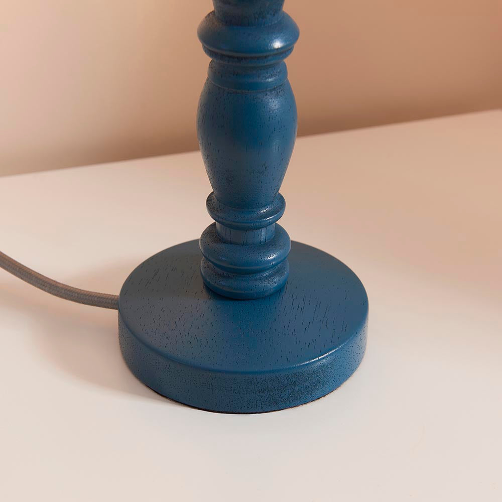 Close-up of the Endon Aldworth table lamp base, showing the turned wooden spindle in satin marlin blue with grey braided flex on a light background.