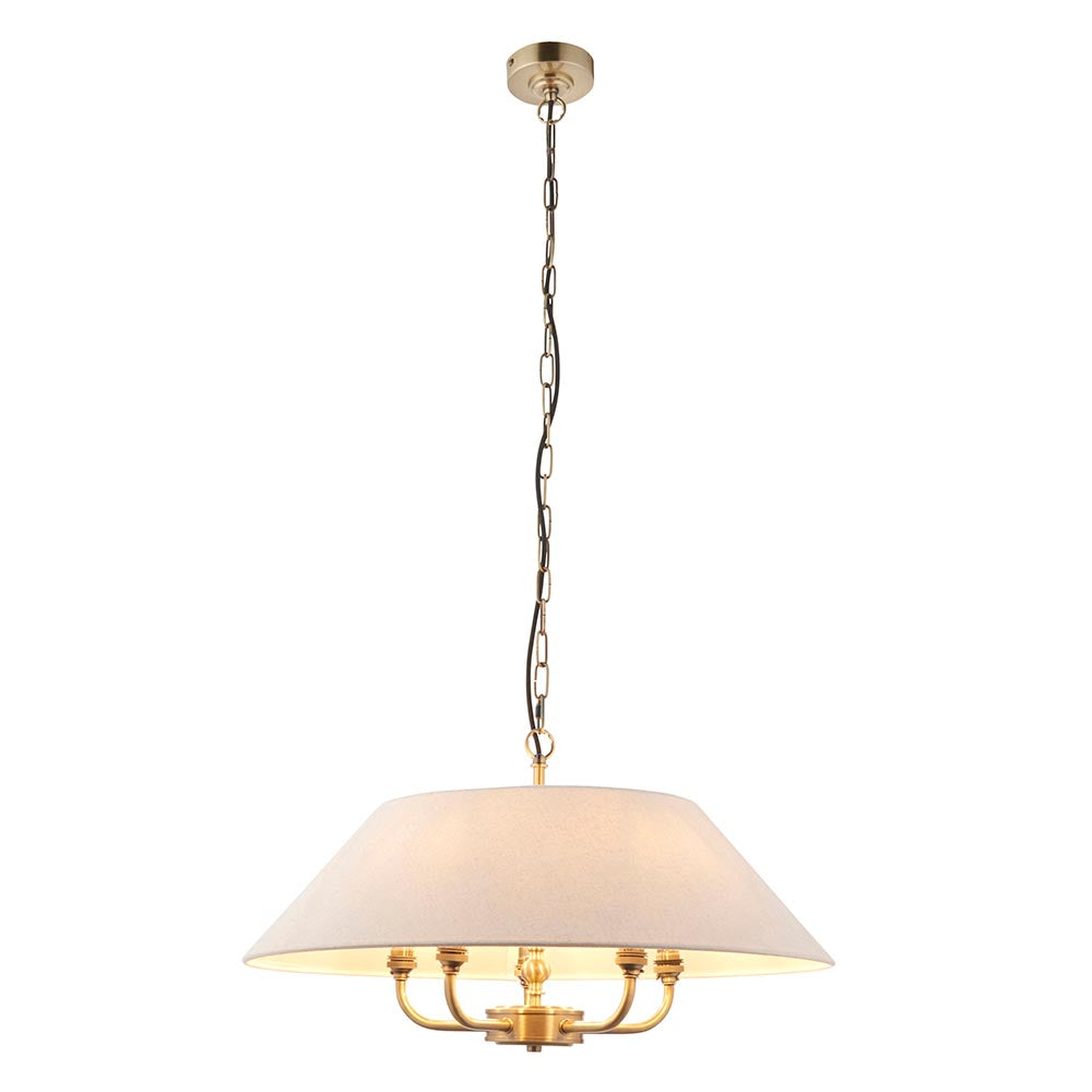 Caldmere 5-light pendant with a wide natural linen drum shade on a brass frame, hung from a chain, shown against a plain white background.