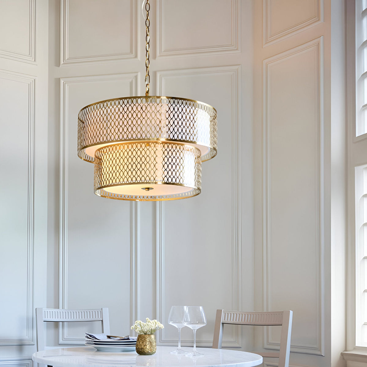 Endon Rosaline 6 light chandelier in gold with two tiered fretwork rings and white inner shade, hanging above a dining table in a panelled room.