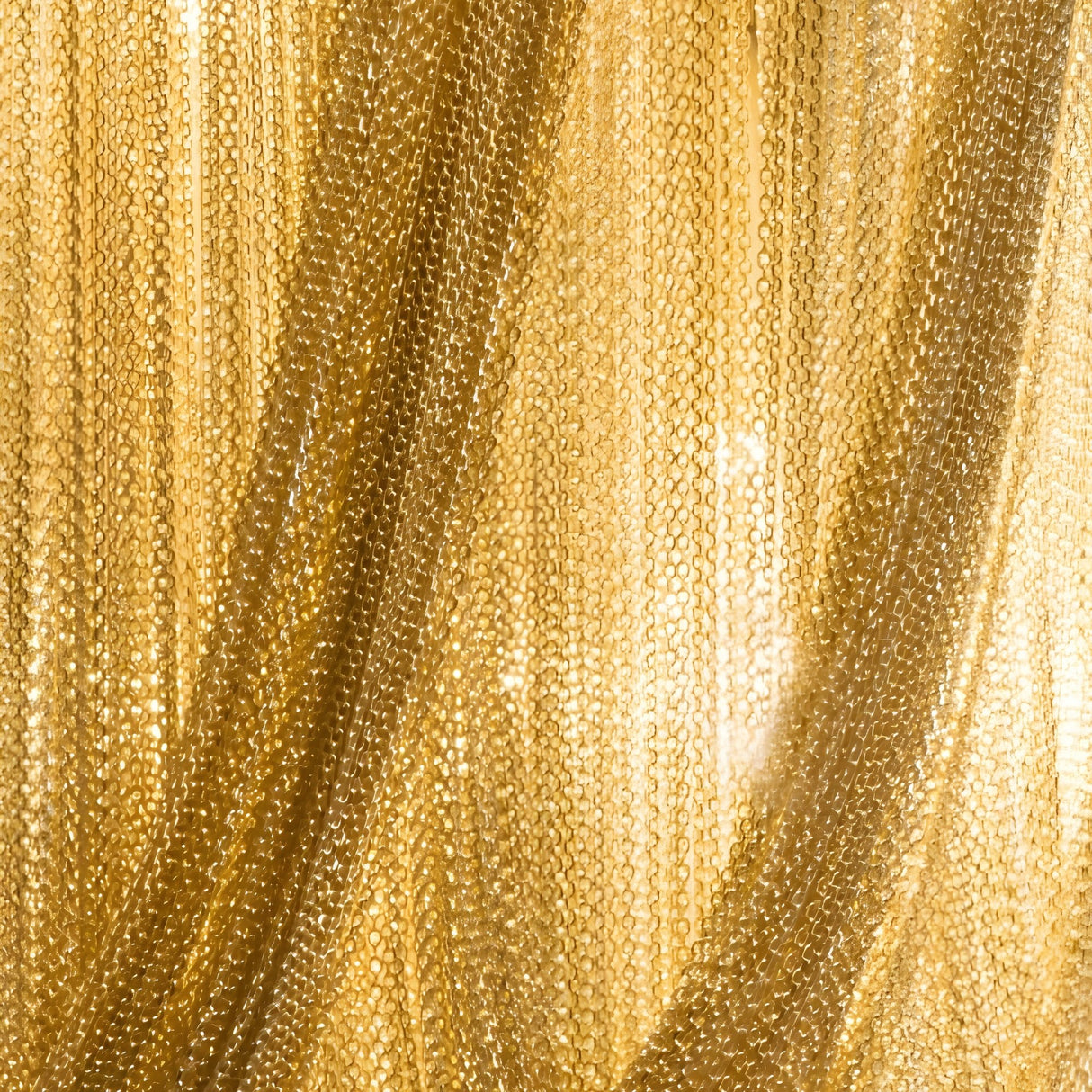 The Mireya 6 Light Metal Chain Veil Wall Light in Gold features overlapping golden chains that create a shimmering, textured curtain, allowing light to filter softly through the metallic links—a stunning touch of contemporary elegance for your walls.