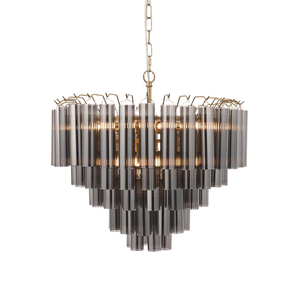 Endon Cranshaw 12 light tiered pendant with cylindrical smokey grey glass on a satin brass frame, hung from a chain against a white background.