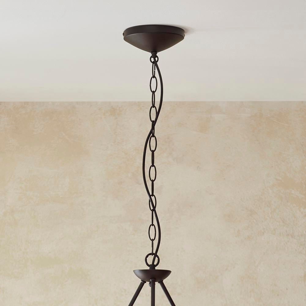 Close-up of the Endon Danemont 3 Light Pendant showing the matt black ceiling rose, chain suspension and top of the metal frame against a neutral wall.